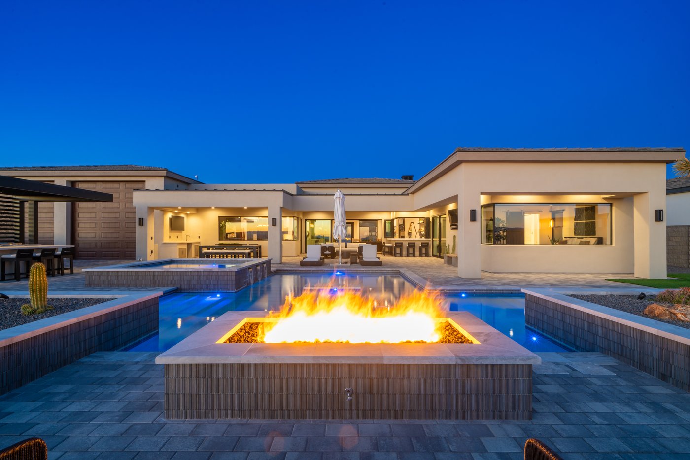 Janecek custom home with twilight pool and fire feature